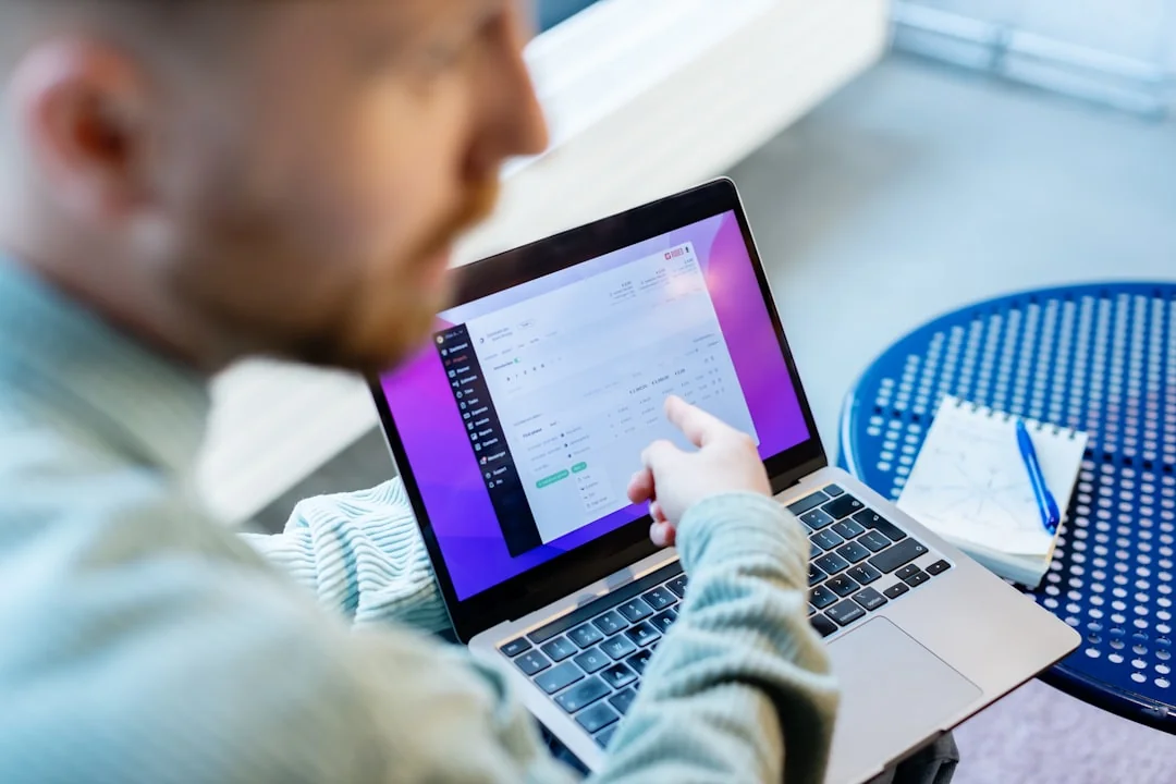 Woman reviewing 2024 social media goals chart on laptop indoors.